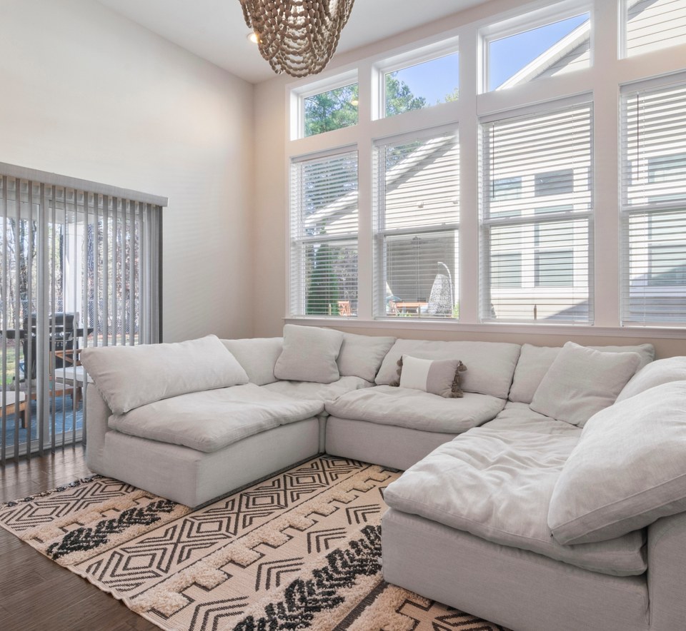 Bright, tidy living room with a white sectional sofa